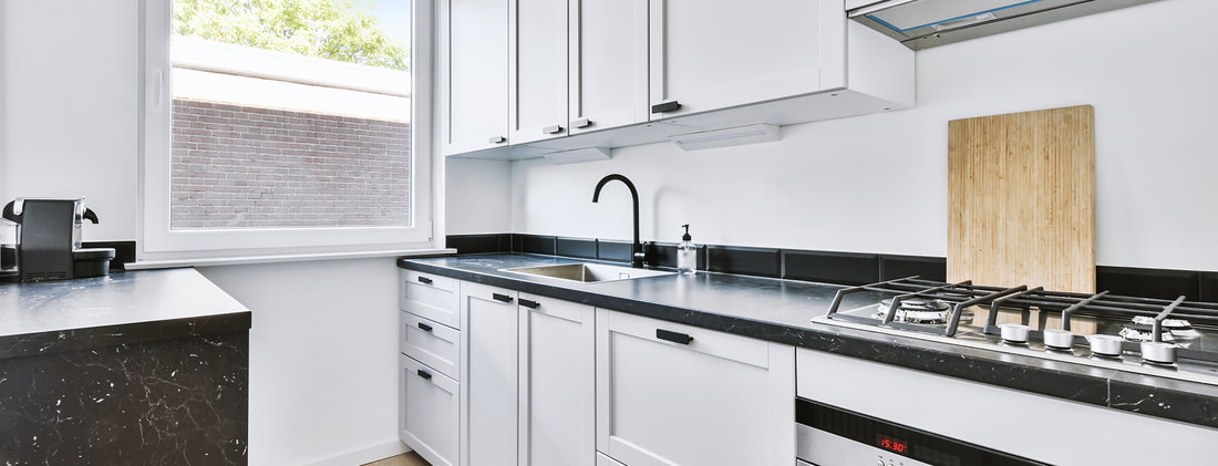 stylish white cabinets with chrome appliances located near near window light modern kitchen apartment5 7