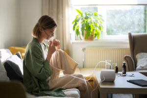 side view woman using nebulizer