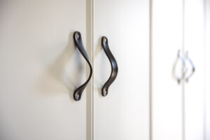 close up black knobs white cabinet