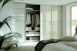 minimalist bedroom featuring stylish sliding door wardrobe with integrated shelves