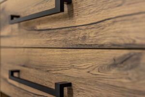 close up modern dark wood furniture with black handles