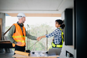 construction team shake hands greeting start new project plan yellow helmet office center consults about their building projectxa