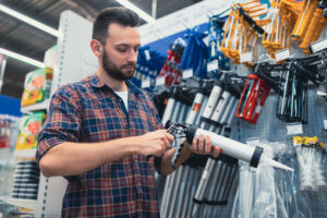 hardware store buyer chooses gun glue sealer