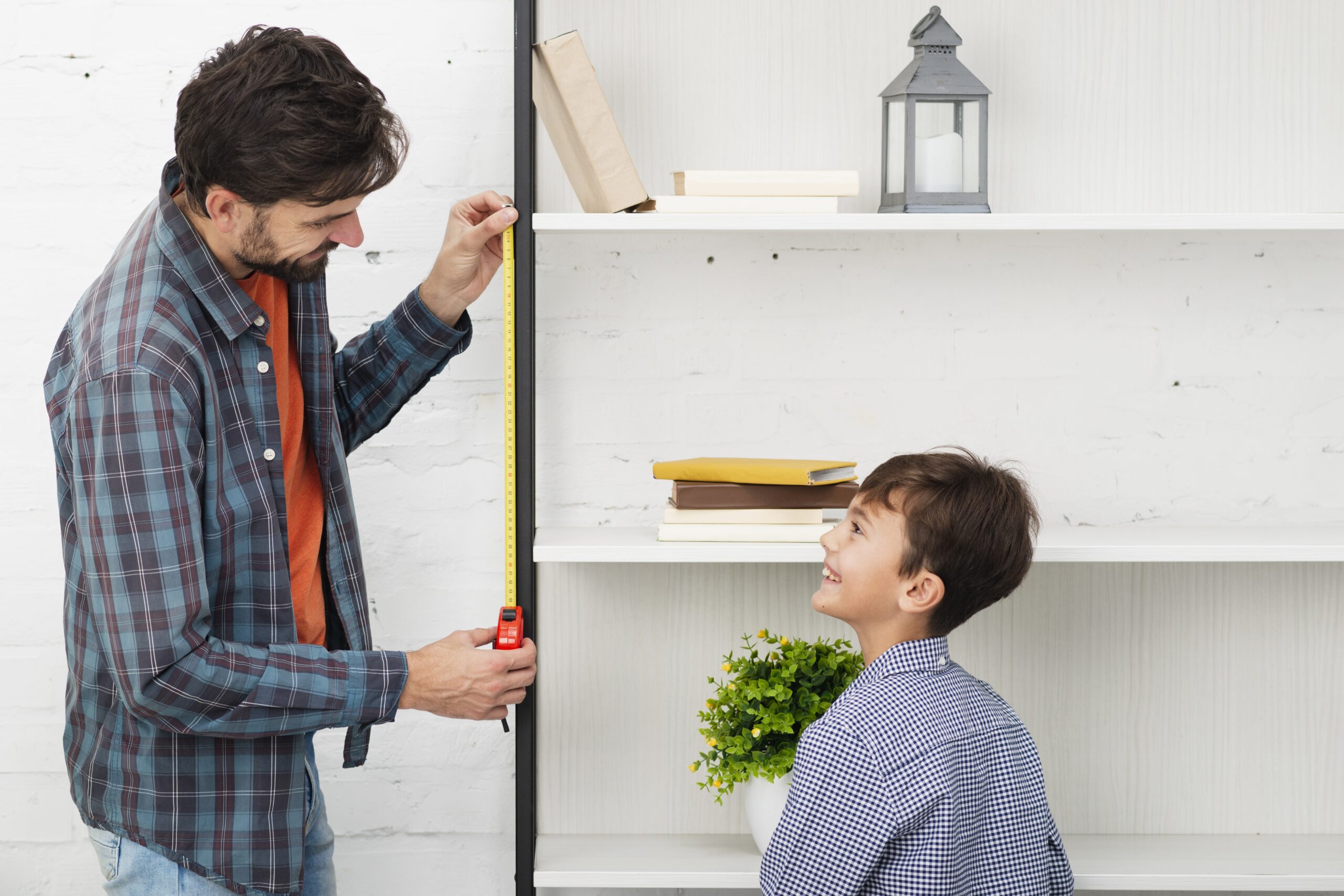 father son measuring shelf scaled