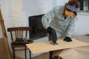 front view woman restoring wooden furniture