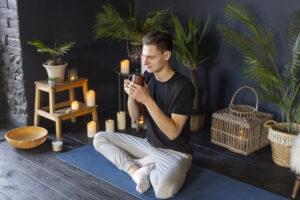 full shot man doing yoga indoors