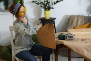 side view woman restoring wooden furniture