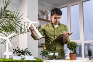 man using tablet eco friendly wind power project layout