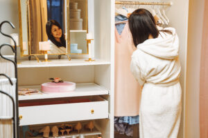 attractive young woman bathrobe choosing dress dressing room home