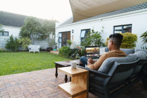 full shot man using laptop outdoors