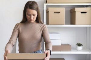 medium shot woman holding box