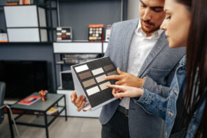 salesman shows color swatches lady customer new kitchen furniture